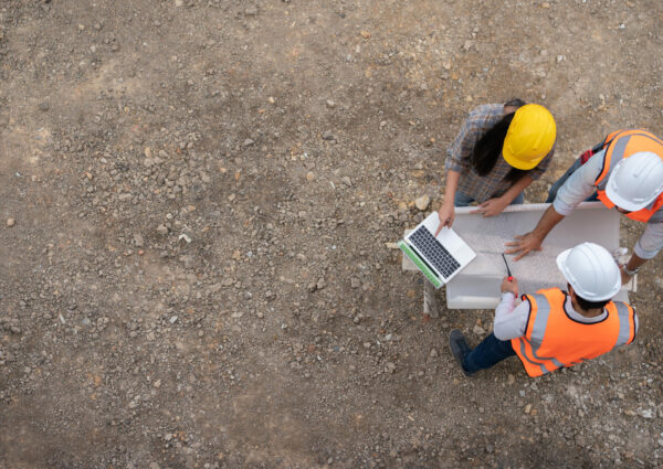 top view engineering team meeting planning Construction workers and engineering team inspect the construction project.