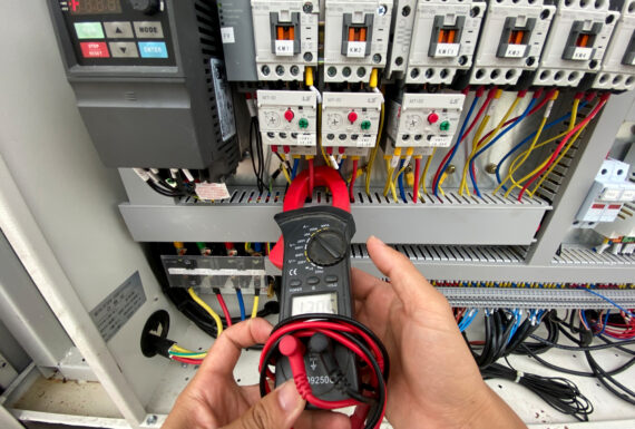 Human hand measuring ampere with meter Human hand measuring ampere with meter